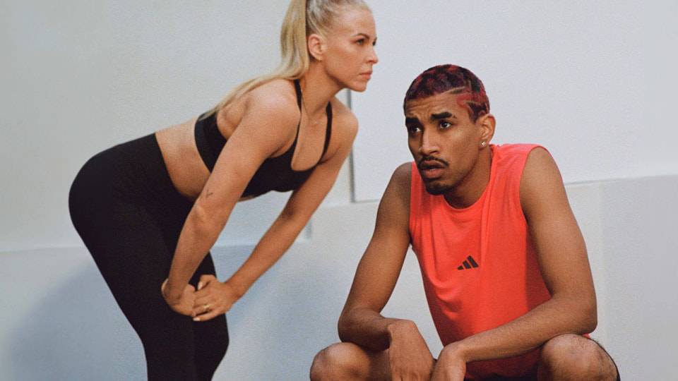 Two people talk after a workout