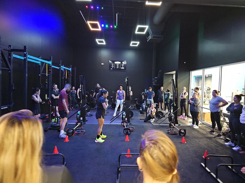 Bright fitness studio at CLUB4 with modern equipment and open space for group workouts.