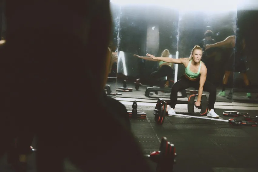 group training Instructor leads a class through a tough workout with smartbars